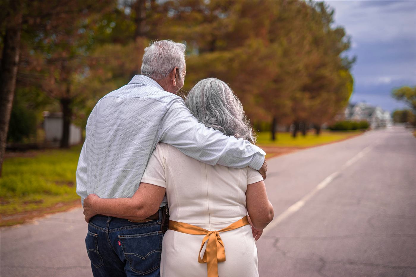 A senior couple walking together, arm in arm