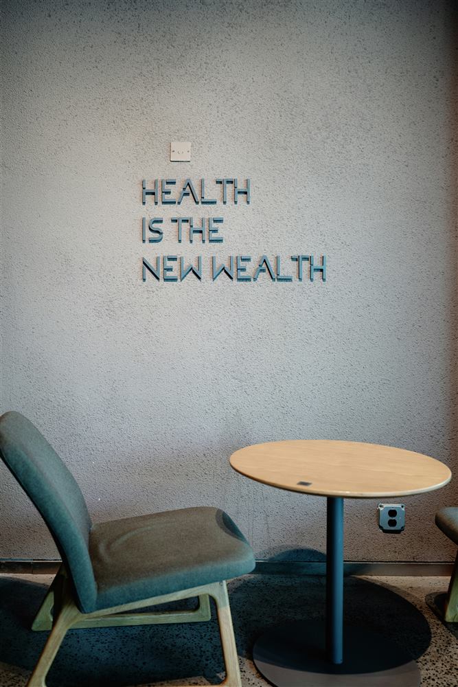A wall reading "Health is the new wealth"