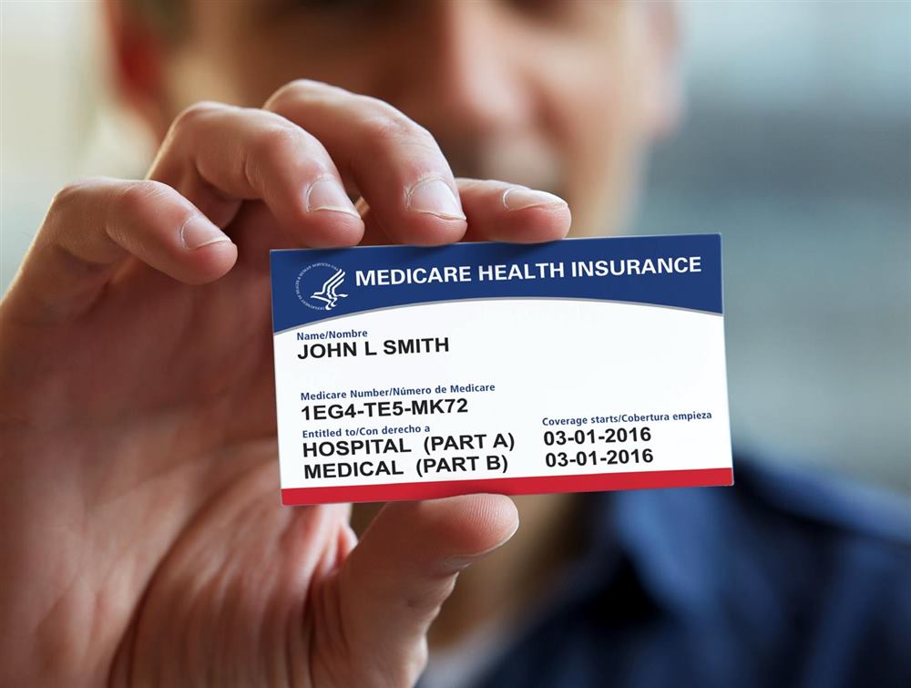 A person holding a Medicare health insurance card